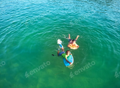 Preview: Aerial view Happy smiling children with bodyboard.