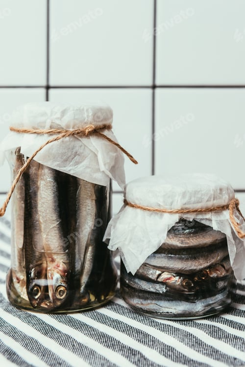 Preview: Pile of salted fish in jars wrapped by strings on towel