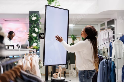 Preview: woman using smart display board to shop for shoes
