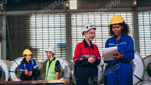 Preview: Team engineers and foreman checking the machinery in detail at factory machines.
