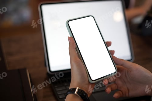 Preview: Mock up. image of woman holding mobile phone with blank white screen.