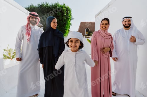 Preview: Emirati family standing together and smiling outdoors