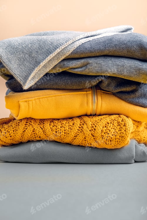Preview: Stacks of gray and yellow clothing