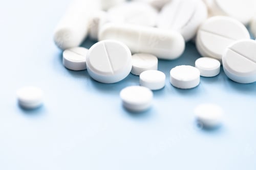 Preview: Different Shapes White Pills on Blue Background.