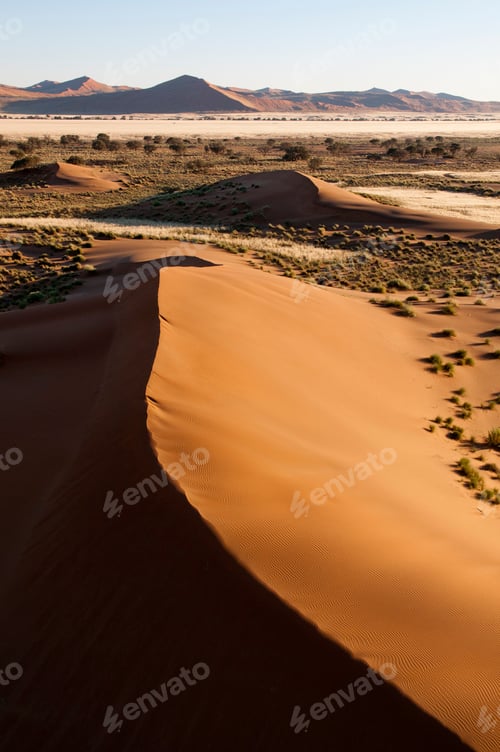 Preview: Golden sand dunes stretching into the horizon at sunset