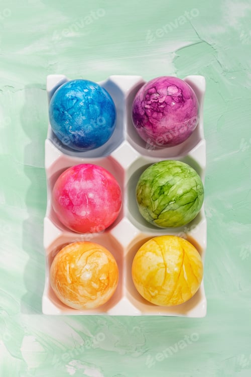 Preview: Multicolored Easter eggs in porcelain storage organizer box on green background