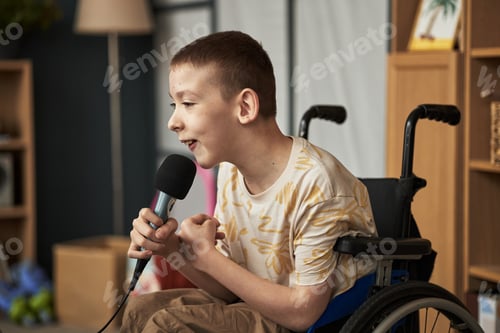 Preview: Smiling Boy with Disability Holding a Microphone