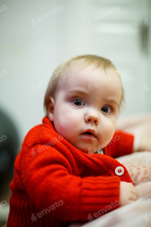 Preview: Adorable Baby in a Red Sweater Indoors