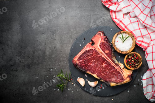 Preview: T-bone beef steak on black with spices