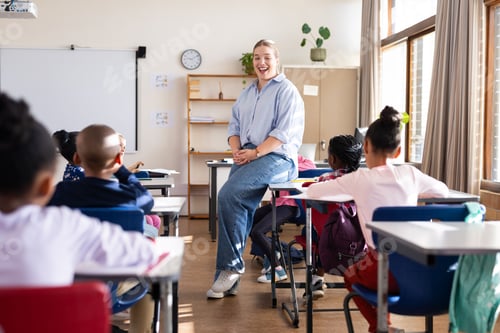 Preview: Engaging with diverse students, female teacher fostering interactive learning in classroom at school