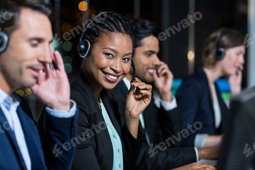 Preview: Portrait Of Businesswoman With Headsets Using Computer At Office Desk