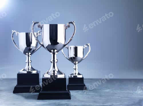 Preview: Still life of three trophies awaiting the winners' presentation