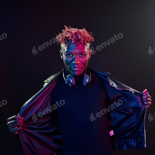 Preview: Futuristic neon lighting. Young african american man in the studio