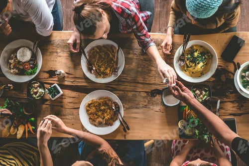 Preview: Top view of Family gathering together at home for eating dinner.
