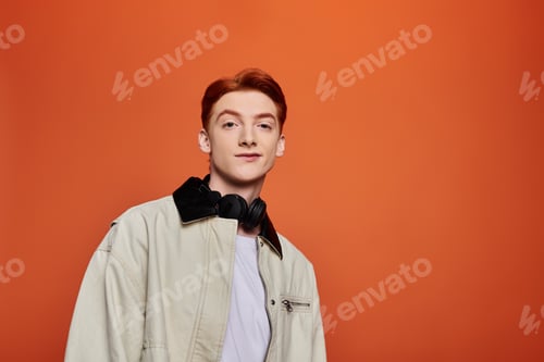 Preview: Emotional young man expressing himself against a vibrant orange background