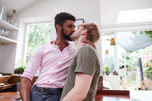 Preview: Loving Male Gay Couple Hugging And Kissing At Home In Kitchen