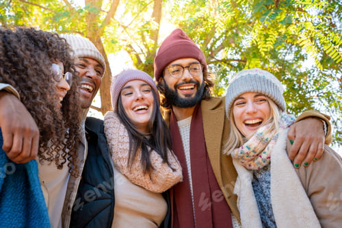 Preview: Friends are sharing a happy moment, smiling for a picture in a park enjoying the fun together.