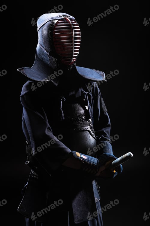 Preview: Kendo fighter in helmet holding bamboo sword on black