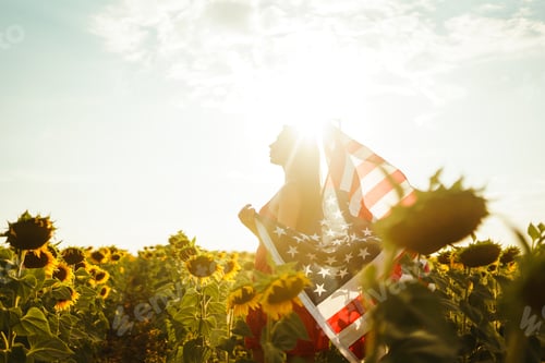 Preview: Beautiful girl in hat with American flag in a sunflower field. 4th of July. Fourth of July. Freedom