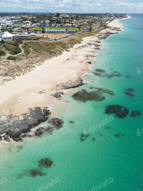Preview: Aerial view of an idyllic beach city situated on the coast of a picturesque blue ocean