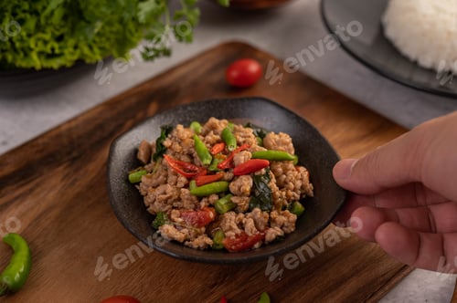 Preview: Spicy minced pork and rice on a black plate.