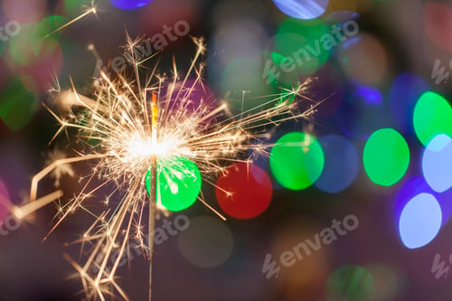 Preview: Christmas and New Year sparkler with bokeh festive background