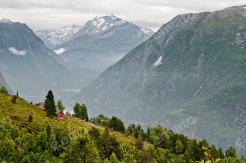 Preview: A cozy red cabin perched on a lush hillside overlooking a majestic fjord