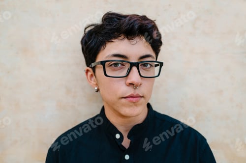Preview: Close up view of a young transgender man looking at camera.