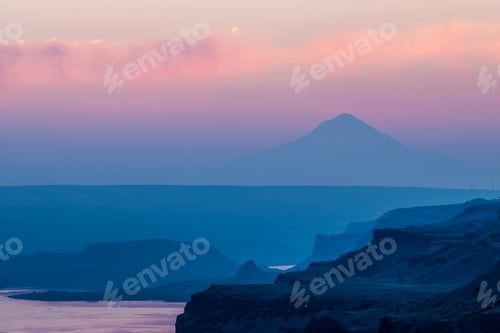 Preview: Vast body of water with a distant hill on a twilight horizon