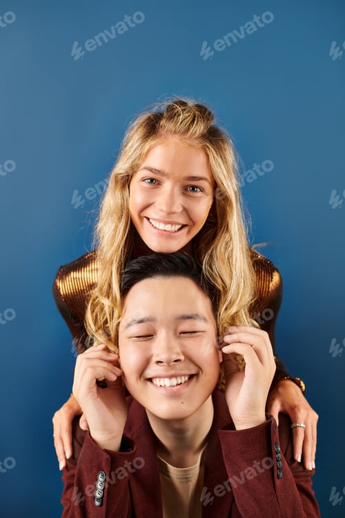 Preview: joyful multiracial friends in stylish clothing smiling at camera while having fun, friendship day