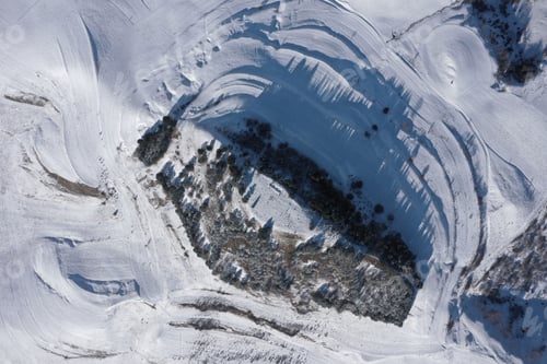 Preview: Aerial View of Snow Covered Countryside Hills and Meadow