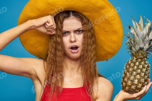 Preview: Woman in yellow hat with pineapple in hands emotions fun lifestyle summer fruit blue background