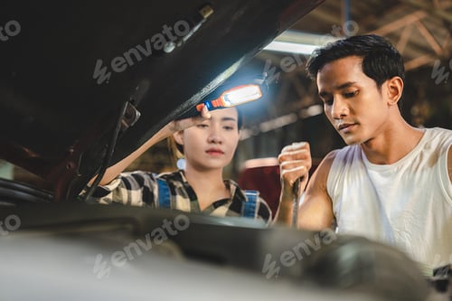 Preview: Professional mechanic technician working on the car engine in garage. auto repair service concept