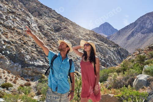 Preview: man and woman tourists hikers looking pointing out the landscape of Cochiguaz