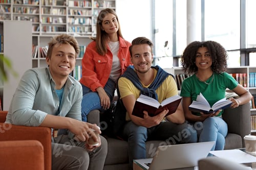 Preview: Group of young people studying at table in library