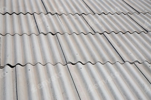 Preview: A fragment of a gray slate roof of an old sample made of asbestos material