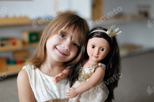 Preview: Child girl hugs and plays with a doll, role-playing and story games,