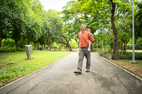 Preview: Grandfather and granddaughter jogging together in the park
