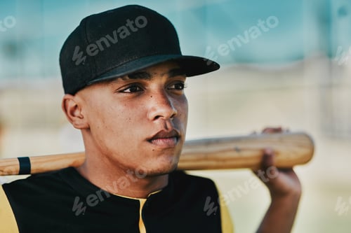 Preview: Shot of a young baseball player holding a baseball bat while posing outside on the pitch