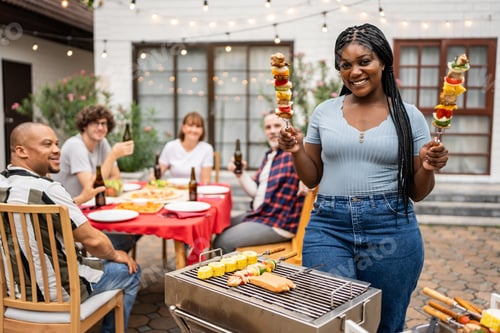 Preview: Portrait of African woman having fun, enjoy party outdoors in garden.