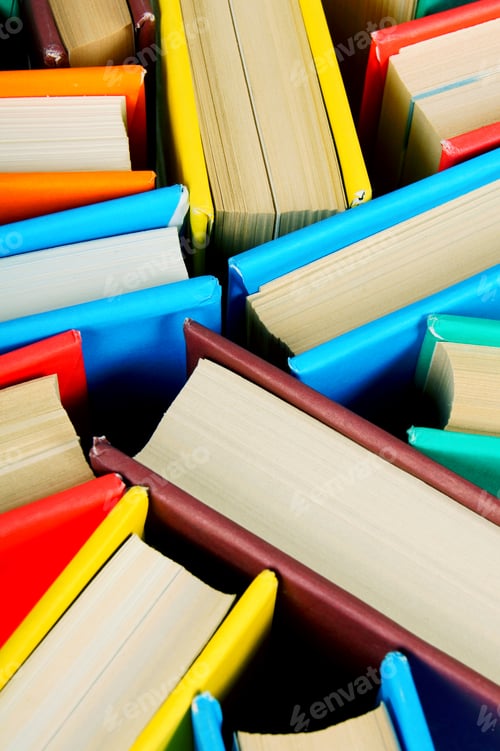 Multi-coloured books from above. Close up.