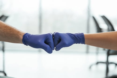 Preview: Focused view. Two doctors are holding hands indoors