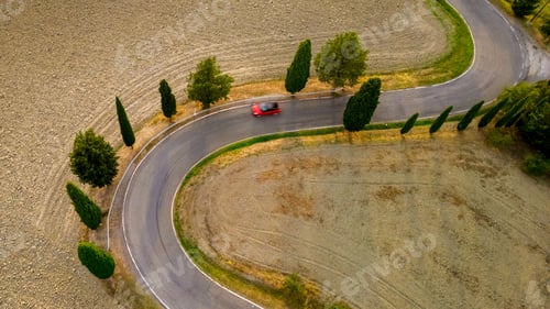 Preview: Winding road through the serene countryside of Tuscany, Italy, inviting leisurely drives at dusk