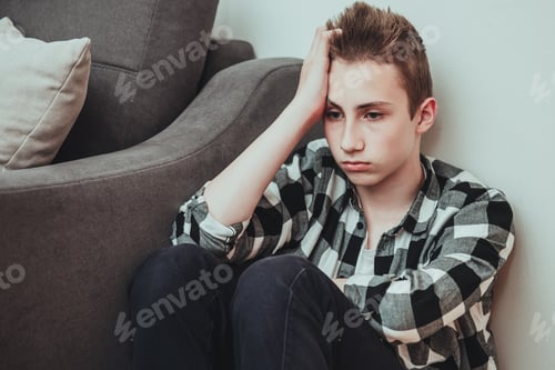 Preview: Sad teen boy sit on the floor thinking of her trouble and unhappy life and close his ears