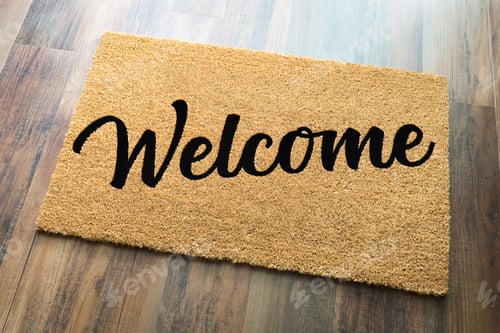 Preview: Tan Welcome Mat On Wood Floor Background.