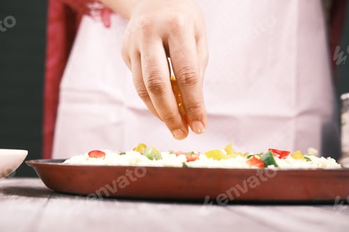 Preview: young women putting cheese on pizza