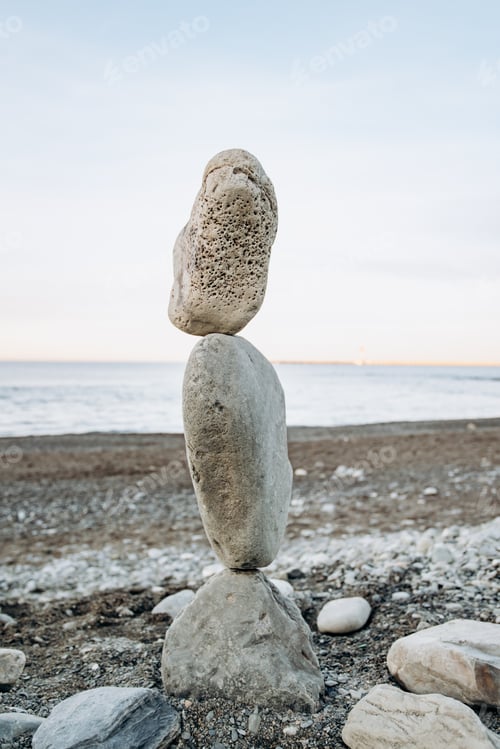 Preview: The figure of stones standing on each other, on the beach against the sea.