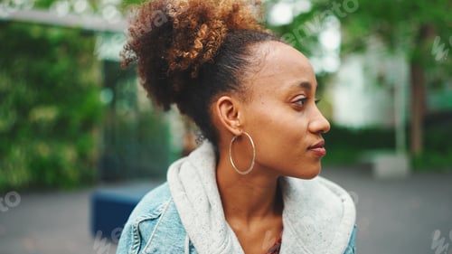 Preview: Woman Posing in Profile Wearing Denim Jacket