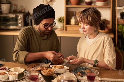 Preview: Friends Sharing Meal in Cozy Kitchen Setting