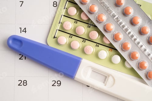 Preview: Pregnancy test and birth control pills on calendar, contraception health and medicine.